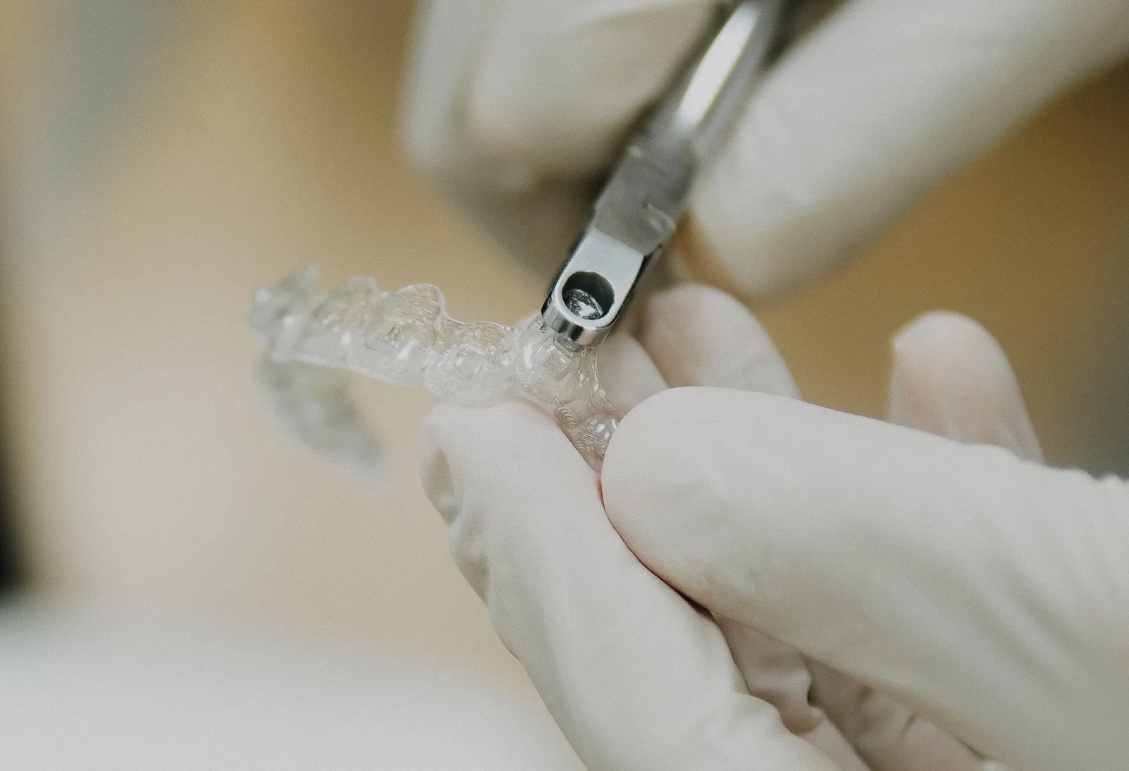 Aligner edge being adjusted in the clinic, showing the importance of clinical finishing regardless of brand