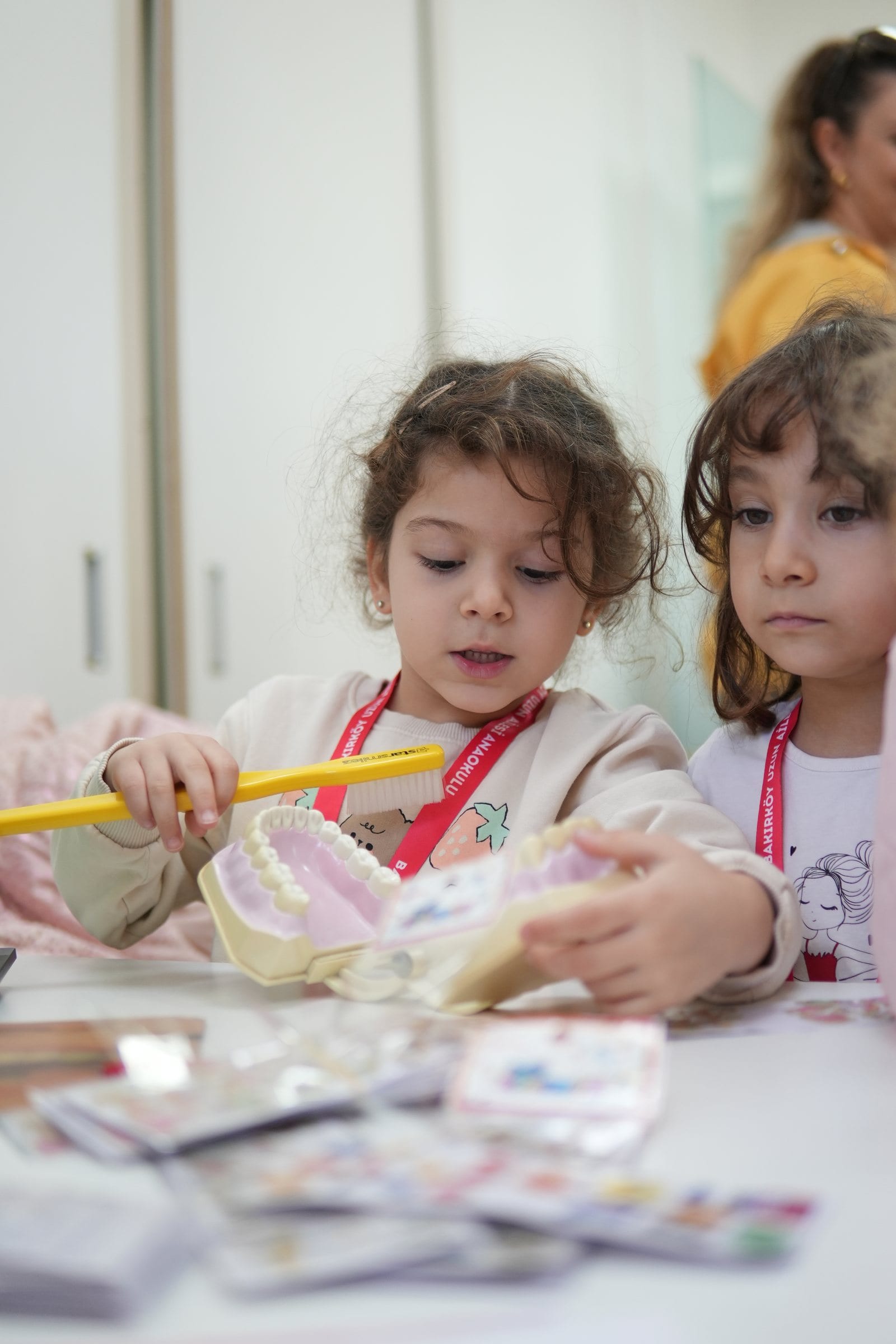 Children learning to brush teeth on a dental model