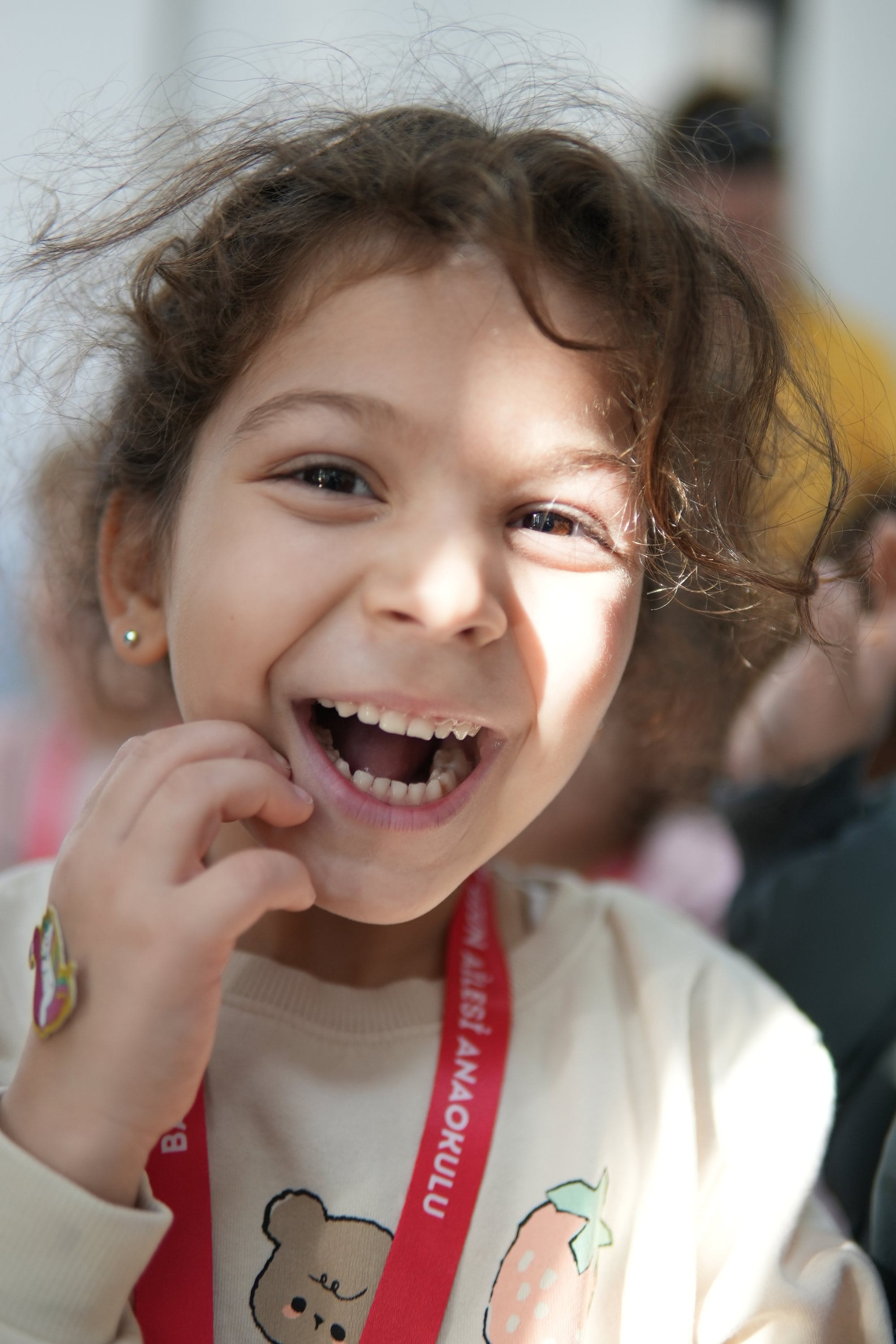 A child laughing brightly at Mosdent